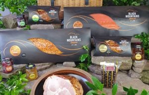 Luxury Smoked Food Wicker Hamper containing whole ham, oak roasted salmon side and smoked side